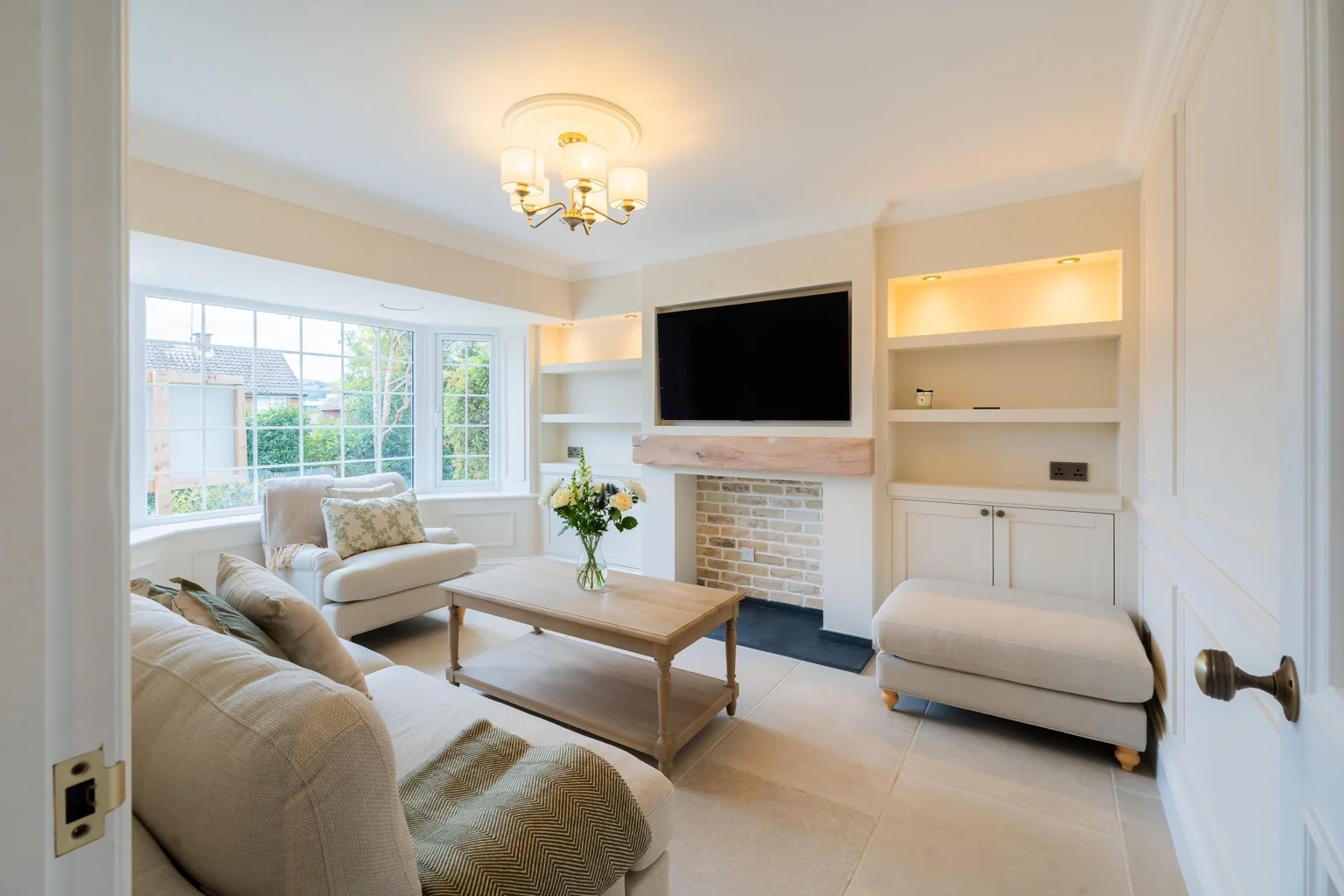 Finished living room with fitted cabinetry and detailed wall finishes